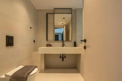 a bathroom with a sink and a toilet and a mirror at Villas Phos and Kallos in Kissamos