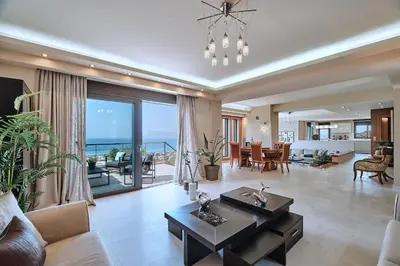 a living room with a view of the ocean at Luxury Villa Argi infinity private pool in Kissamos