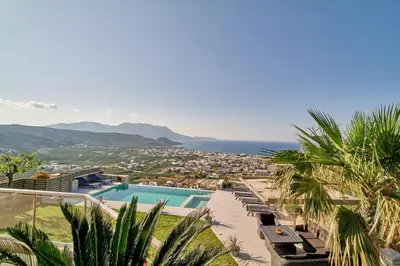 a villa with a pool and a view of the ocean at Luxury Villa Argi infinity private pool in Kissamos