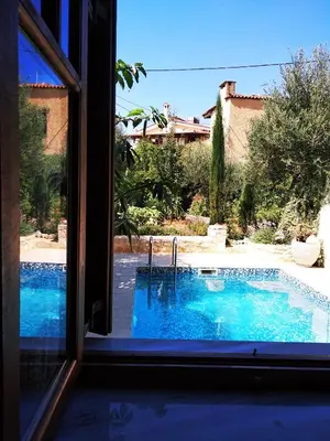 a view of a swimming pool through a window at Villa Eleonas in Vamos