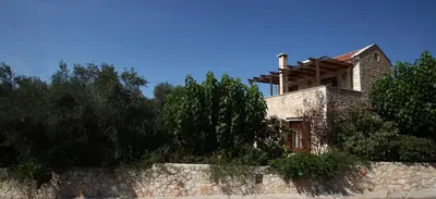 a house on top of a stone wall at Villa Eleonas in Vamos