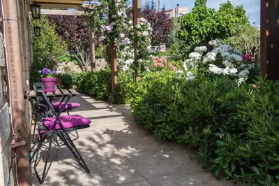 a patio with chairs and a bunch of flowers at Villa Eleonas in Vamos