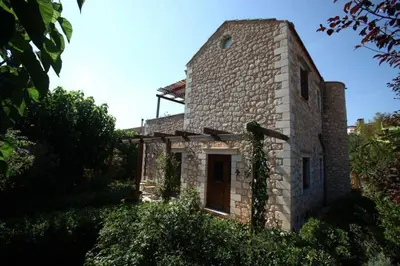 a brick building with vines growing on the side of it at Villa Eleonas in Vamos