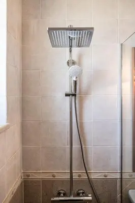 a shower with a shower head in a bathroom at VILLA AMANTELLA in Stavros
