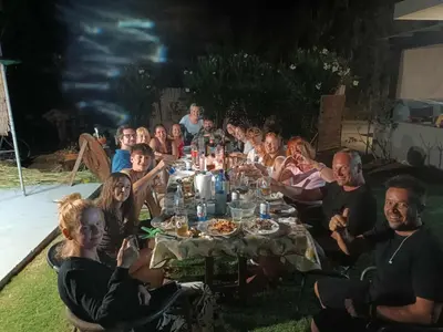 a group of people sitting around a long table at SEA BREEZE APARTMENTS in Kolymvari