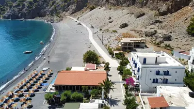 a view of a beach with buildings and the ocean at Agia Roumeli APARTMENT in Agia Roumeli