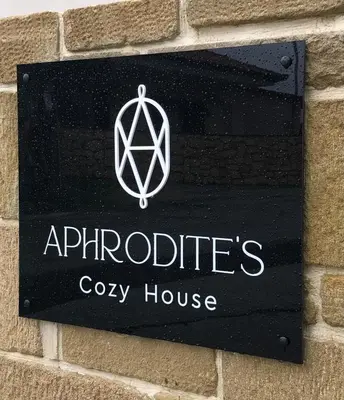 a sign for a cypsy house on a brick wall at Aphrodite’s Cozy House in Kolymvari