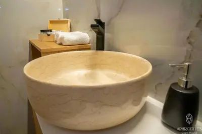 a bathroom with a bowl sink and a soap dispenser at Aphrodite’s Cozy House in Kolymvari