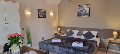 a hotel room with a bed and a table at Secret Garden Hotel in Maleme