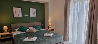 a bedroom with a bed with two towels on it at Secret Garden Hotel in Maleme