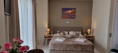 a bedroom with a bed with two towels on it at Secret Garden Hotel in Maleme