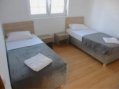 a room with two beds and a window at Modern villa with infinity pool close to the sea in Tavronitis
