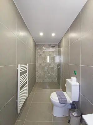 a bathroom with a toilet and a shower at Modern villa with infinity pool close to the sea in Tavronitis