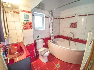 a bathroom with a tub and a toilet and a sink at Modern villa with infinity pool close to the sea in Tavronitis