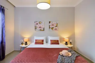 a bedroom with a bed and two tables with hats on it at CASA MARIGO (OLD HARBOUR) in Chania Town