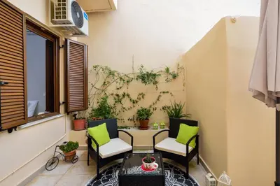 a small balcony with a table and chairs at CASA MARIGO (OLD HARBOUR) in Chania Town