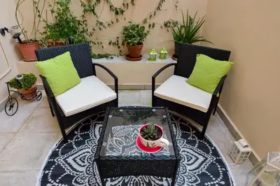 two chairs and a coffee table on a patio with a table at CASA MARIGO (OLD HARBOUR) in Chania Town