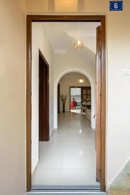 a hallway with a door leading to a living room at CASA MARIGO (OLD HARBOUR) in Chania Town