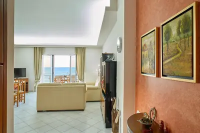 a living room with a couch and a view of the ocean at Sea View House in Kissamos