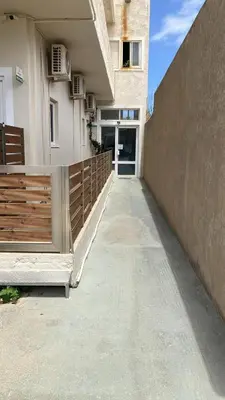 a hallway of a building with a fence and a door at Sea View House in Kissamos