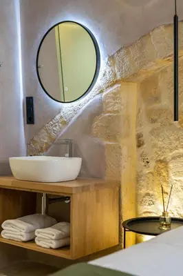 a bathroom with a sink and a mirror at Monk Rooms in Chania Town