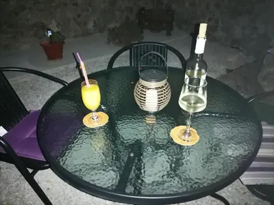 a table with a bottle of wine and two glasses at Lemon Tree House in Kalyves