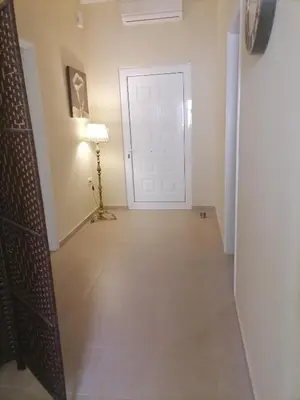 a hallway with a white door and a lamp at Lemon Tree House in Kalyves