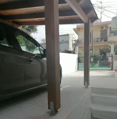 a car parked under a cover in a parking lot at Lemon Tree House in Kalyves