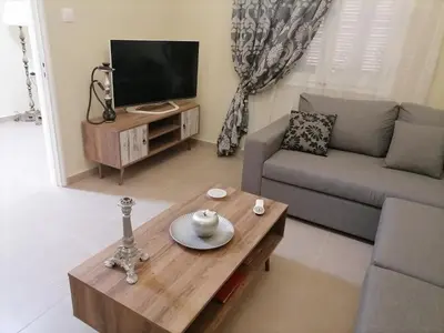 a living room with a couch and a coffee table at Lemon Tree House in Kalyves