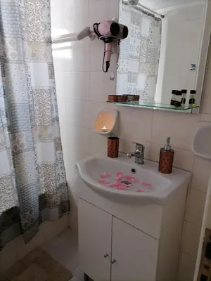 a bathroom with a sink and a mirror at Lemon Tree House in Kalyves