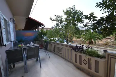 a balcony with a table and chairs and a fence at Paradise House with Private Pool in Kissamos