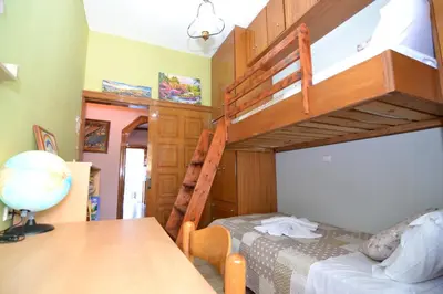 a bedroom with a bunk bed and a table at Paradise House with Private Pool in Kissamos