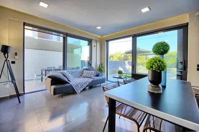 a living room with a couch and a table at Villa Maripol by PosarelliVillas in Galatás