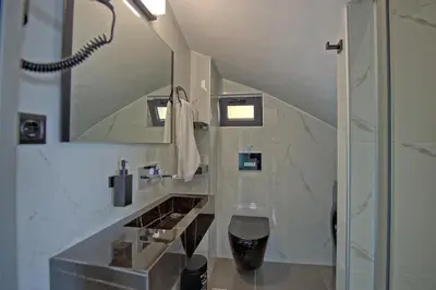a bathroom with a shower and a sink and a mirror at Villa Popi - modern villa with private pool by PosarelliVillas in Galatás