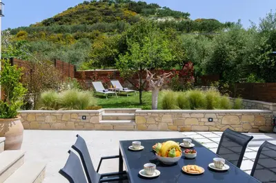 a blue table with a bowl of fruit on it at Effrosini Panorama View in Nopíyia