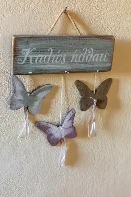 three butterfly ornaments are hanging on a wall at SpiliaInn in Spiliá