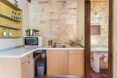 a kitchen with a sink and a microwave at SpiliaInn in Spiliá