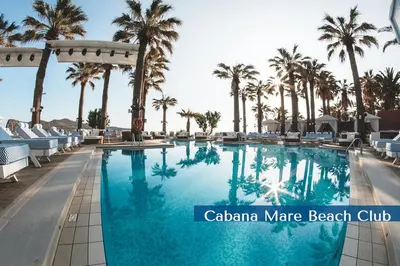 a swimming pool at a resort with palm trees at Cabanavillas Casablanca by PosarelliVillas in Plaka