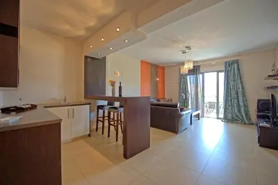 a large kitchen and living room with a couch at Cabanavillas Casablanca by PosarelliVillas in Plaka