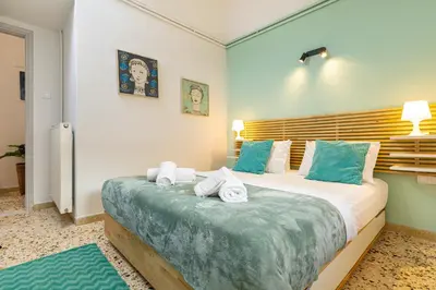 a bedroom with a large bed with towels on it at Golden Key apartments in Chania Town
