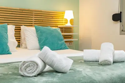 a bedroom with two rolls of towels on a bed at Golden Key apartments in Chania Town