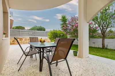 a table and chairs on a patio with a view at Golden Key apartments in Chania Town