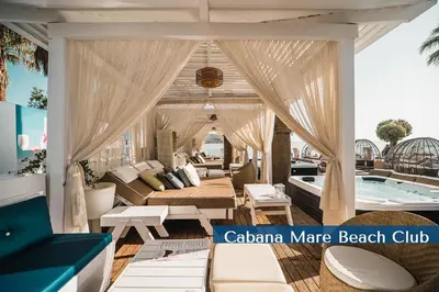 a living room with a couch and a swimming pool at Cabanavillas Rio by PosarelliVillas in Agia Marina Nea Kydonias