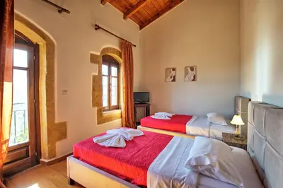 a bedroom with two beds and a window at Villa Sevi Grande by PosarelliVillas in Káto Vení