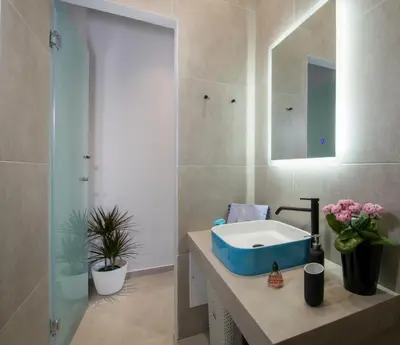 a bathroom with a sink and a mirror at Luxury Villa Eva-Mari with jacuzzi, 50m from the beach in Stalos