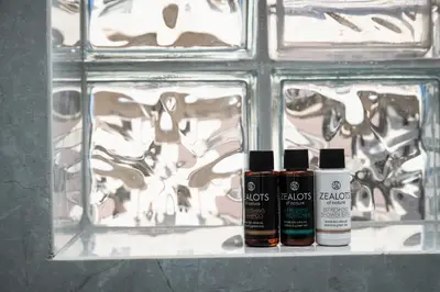three bottles of essential oils sitting on a shelf in front of a wall at Archin Boutique suites in Chania Town