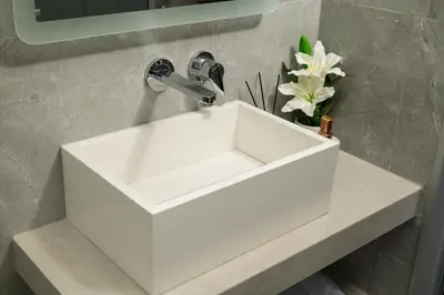 a bathroom with a white sink in a bathroom at Archin Boutique suites in Chania Town
