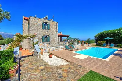 a villa with a swimming pool and a house at Villa Antina by PosarelliVillas in Litsárdha