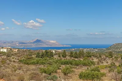 a view of the ocean and a mountain at Villa Antina by PosarelliVillas in Litsárdha