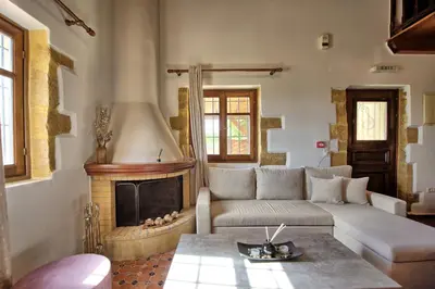 a living room with a couch and a fireplace at Villa Romantic Sevi by PosarelliVillas in Káto Vení